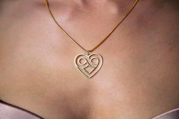 Elegant heart infinity necklace worn on neck