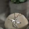 Silver angel pendant with Kalashnikov