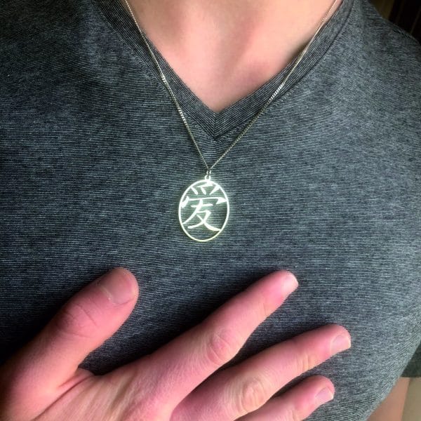 Minimalist kanji 愛 LOVE pendant symbolizing love, connection, and emotional depth.